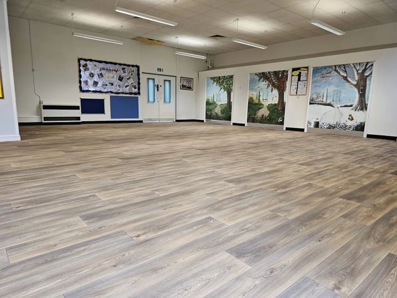 Wood-plank flooring in a bright, spacious room
